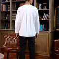man standing in back view dressed teluk belanga white top