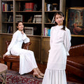 mother and daughter donning jasmine kurung set white polka dot, pose for the camera 
